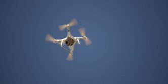 white and blue airplane in mid air