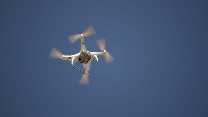 white and blue airplane in mid air