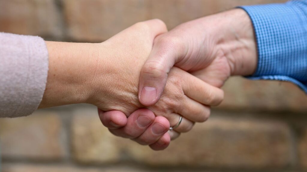 Two people are shaking hands.