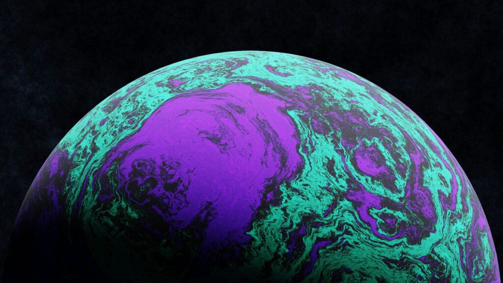A close up of a purple and green ball on a black background