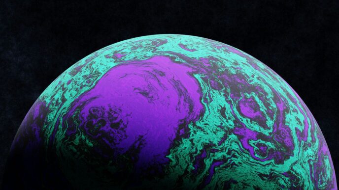 A close up of a purple and green ball on a black background