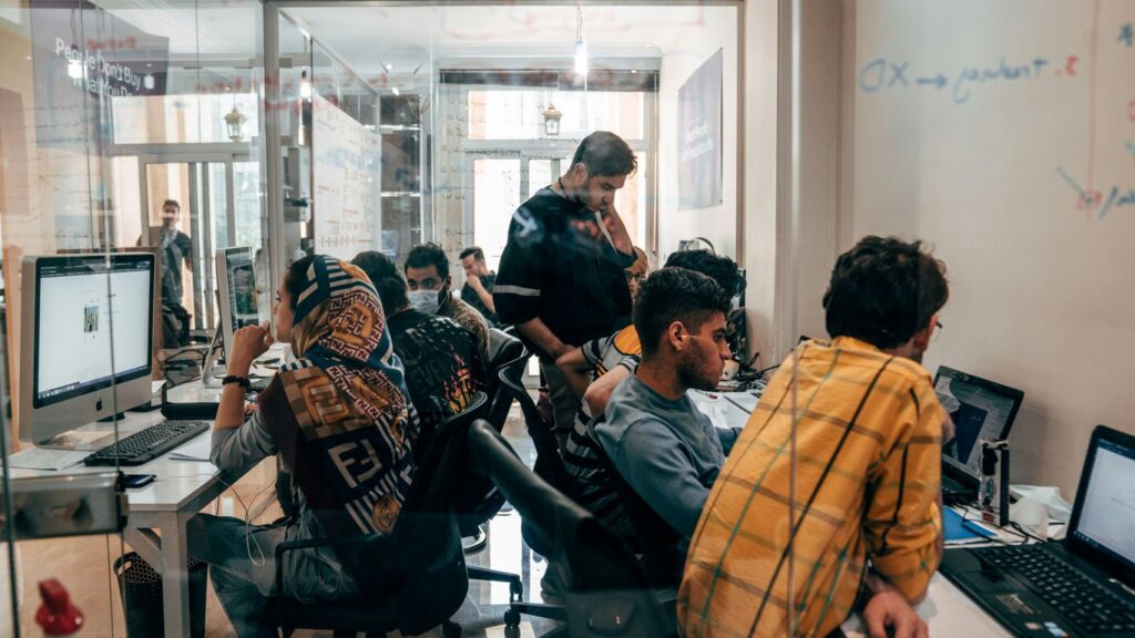 a group of people sitting at computers