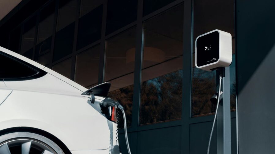 a white car plugged in to a charging station