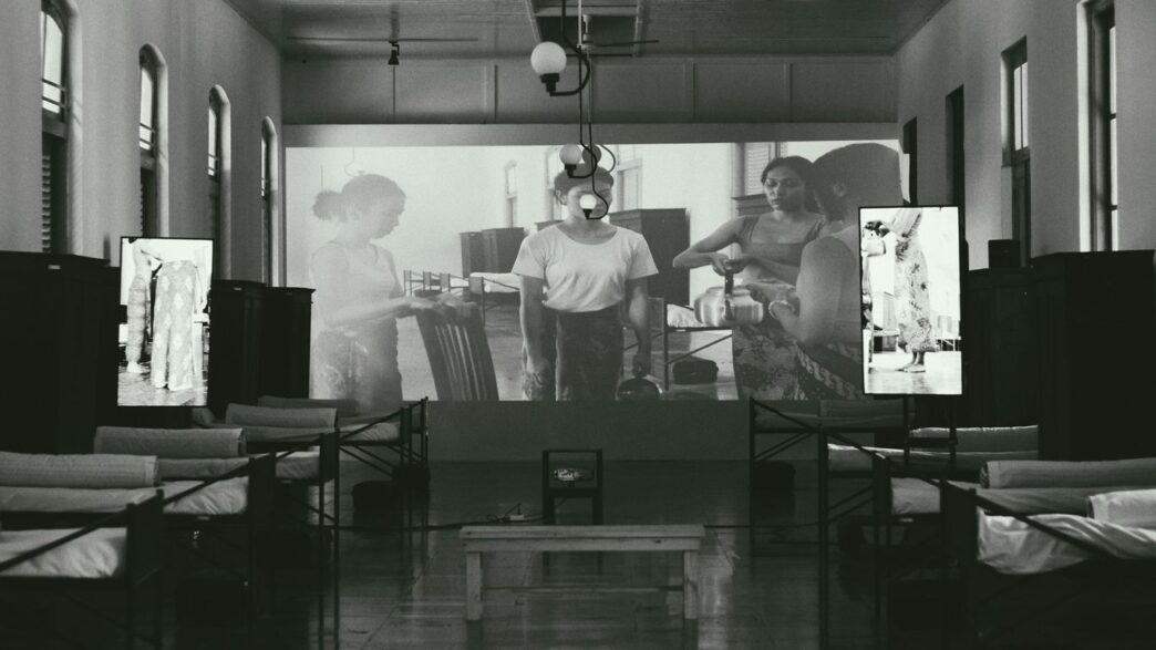 a black and white photo of people in a room