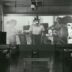 a black and white photo of people in a room