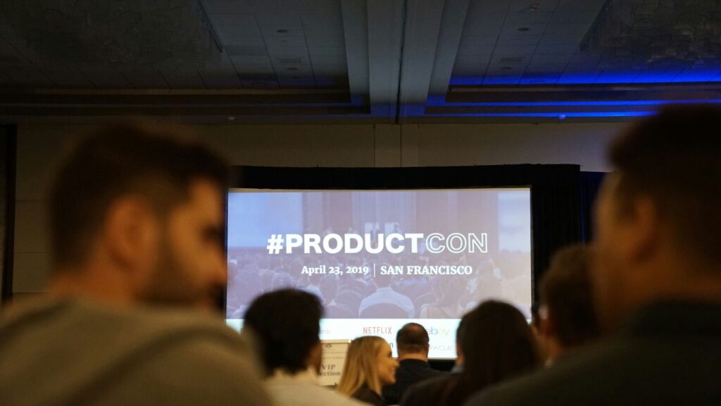 people in conference with projector screen in front