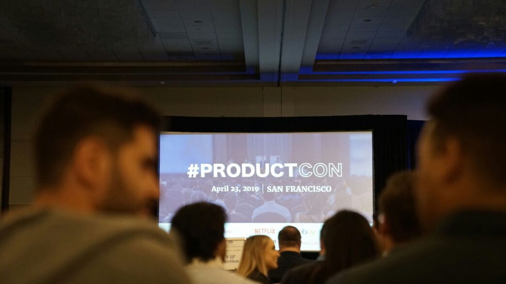 people in conference with projector screen in front