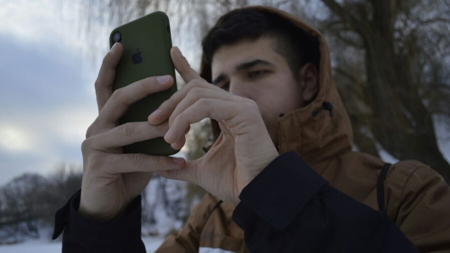 a man holding a cell phone up to his face