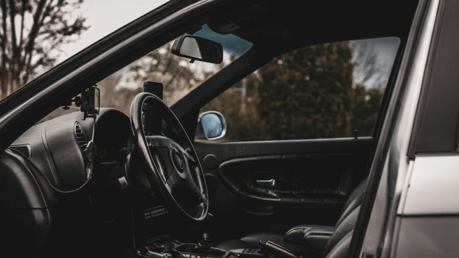 the interior of a car with a steering wheel and dashboard