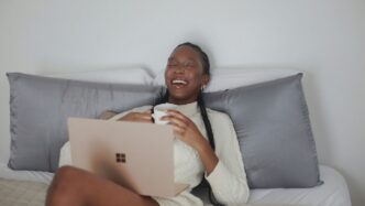 person in white long sleeve shirt holding Surface device
