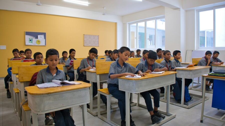 A group of children sitting at desks in a classroom
