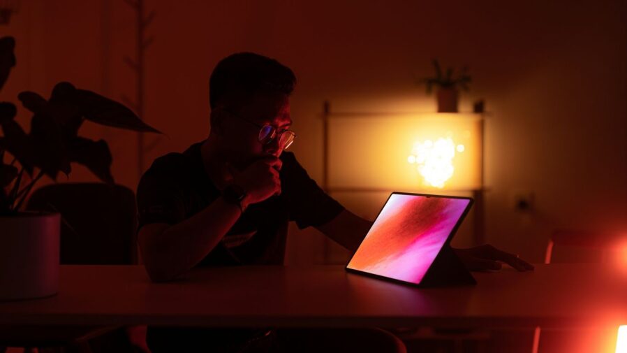 a man sitting in front of a laptop computer