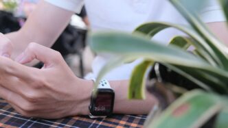 person wearing silver aluminum case apple watch with white sport band
