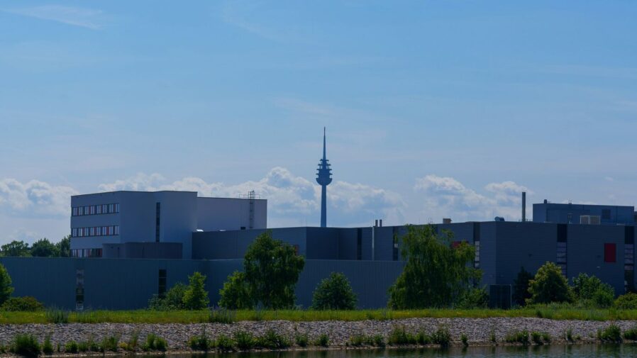 a view of a building with a tower in the background