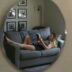 A woman laying on a couch reading a book