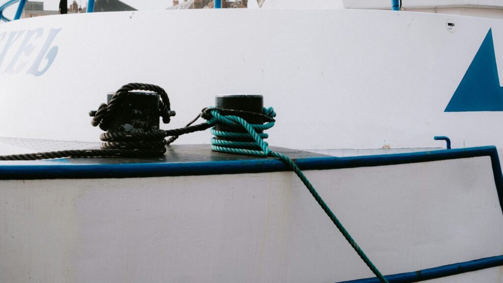 a group of black bags on a white boat
