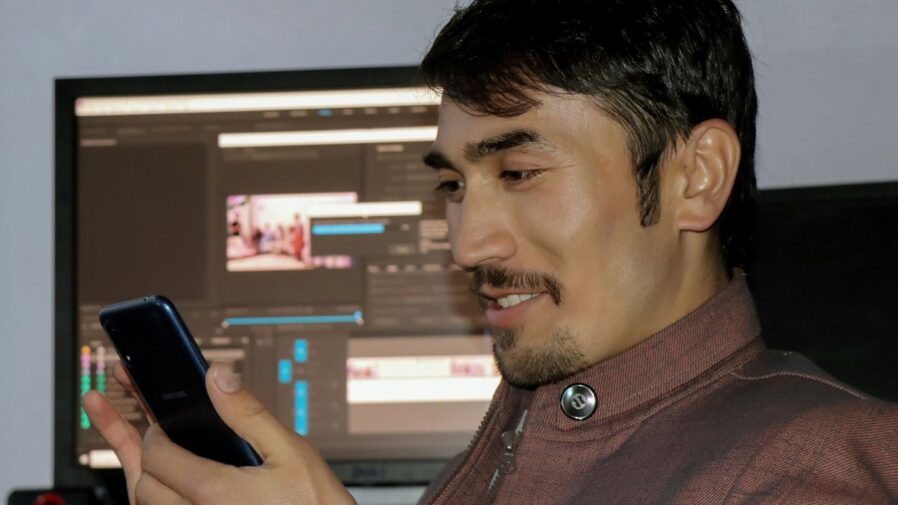 a man is looking at his cell phone