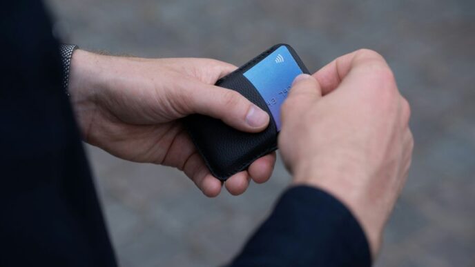 a person holding a cell phone in their hand