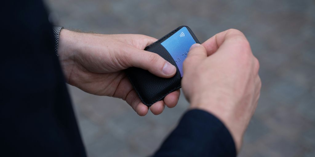a person holding a cell phone in their hand