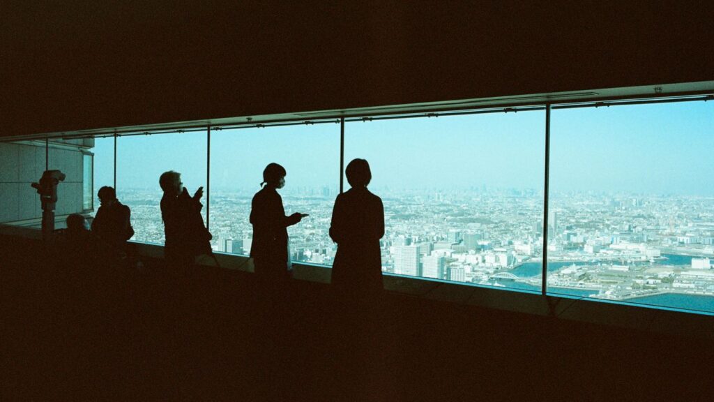 a group of people standing in front of a window