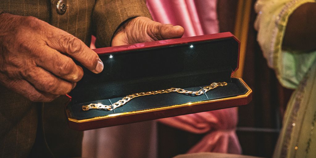 A man holding a box with a chain on it