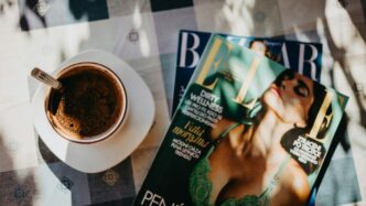 A cup of coffee and a magazine on a table