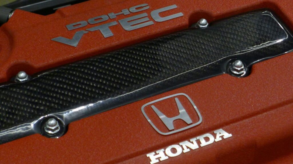 a close up of the hood of a red car