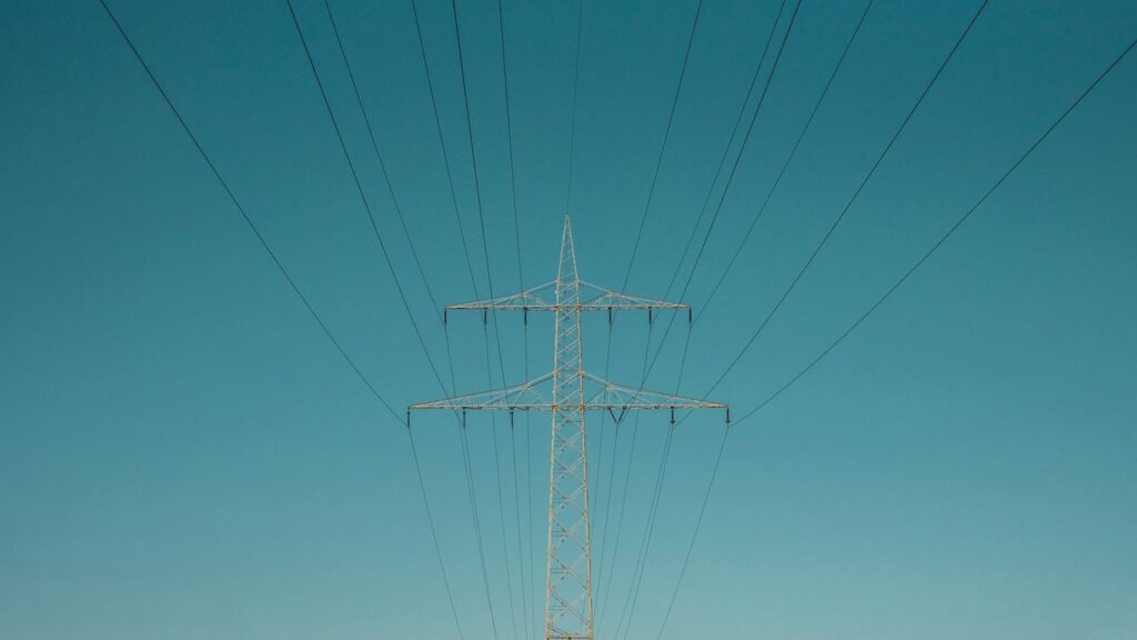 white electric post under blue sky during daytime