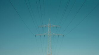 white electric post under blue sky during daytime