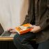 a person sitting on a table with a laptop