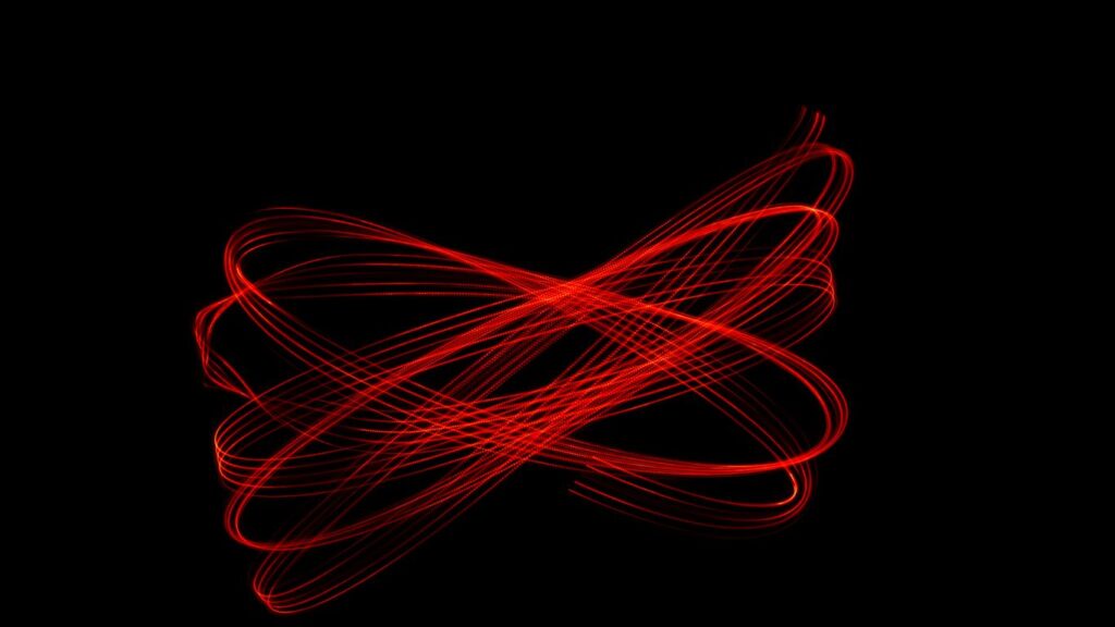 A blurry image of a red object on a black background