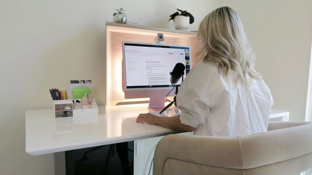 a woman sitting at a desk with a computer