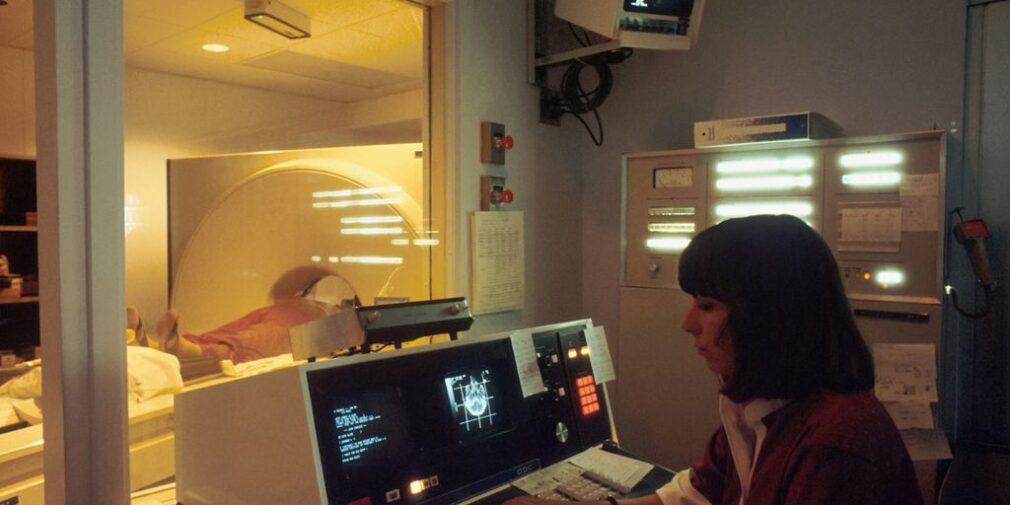 a woman sitting in front of a laptop computer