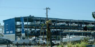 a boat yard with boats and a large building