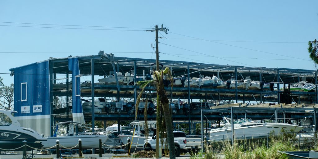 a boat yard with boats and a large building