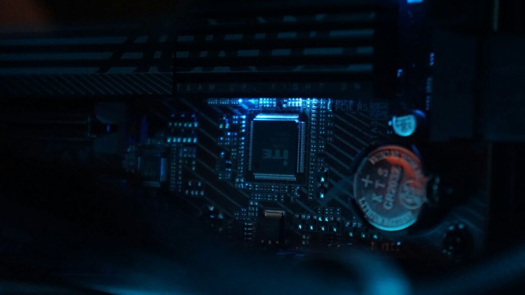 A close up of a computer motherboard in a dark room
