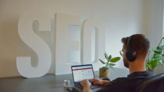 a man sitting in front of a laptop computer