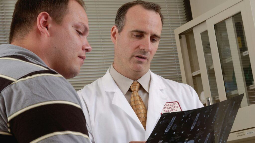 man in white dress shirt holding black tablet computer