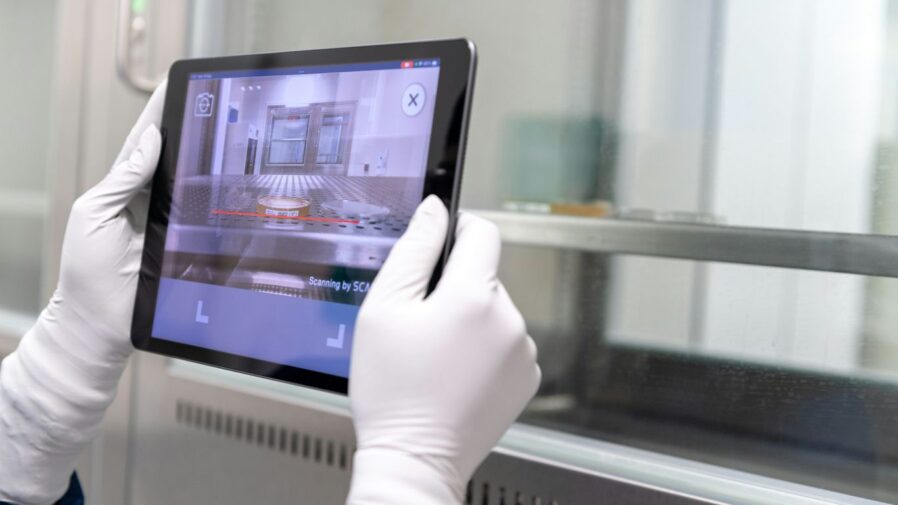 a hand holding a tablet