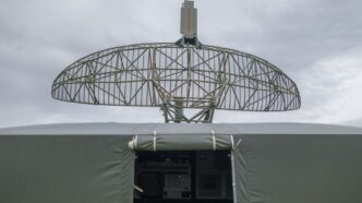 a satellite dish mounted on top of a military vehicle