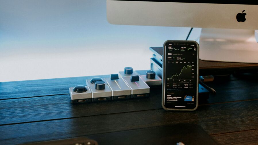 a remote control sitting next to a computer monitor