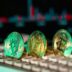 Cryptocurrency coins sit on a keyboard.