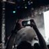 person taking photo of people performing on stage