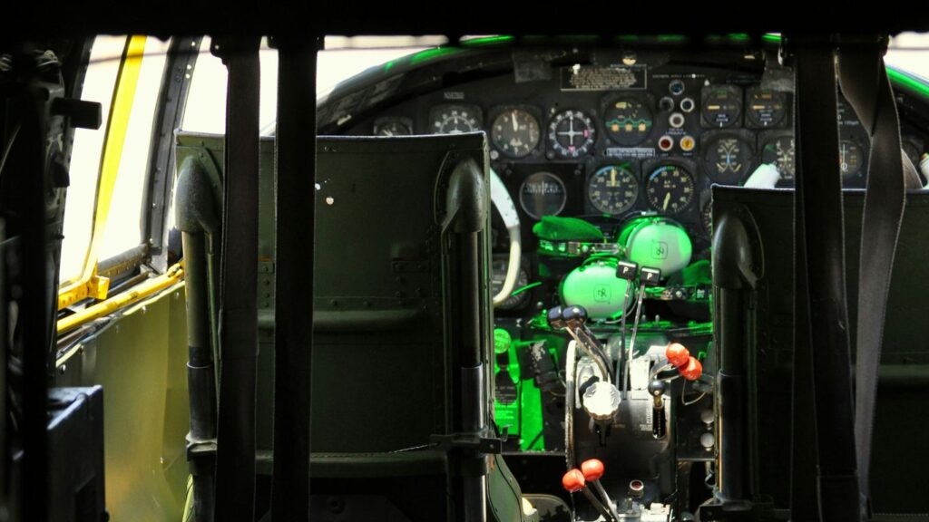 the cockpit of an airplane with a green light on