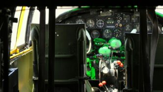 the cockpit of an airplane with a green light on