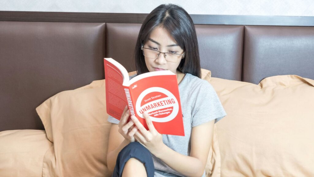 woman in gray crew neck t-shirt holding red and white box