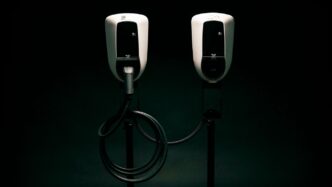 a couple of black and white phones on a black background