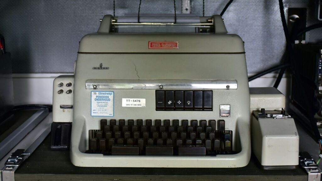 an old typewriter sitting on top of a table