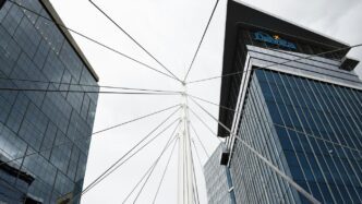 a view of two tall buildings from the ground