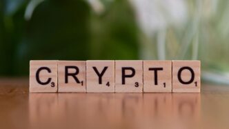 A wooden block spelling crypt on a table